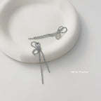 Crystal bow tassel clip earrings