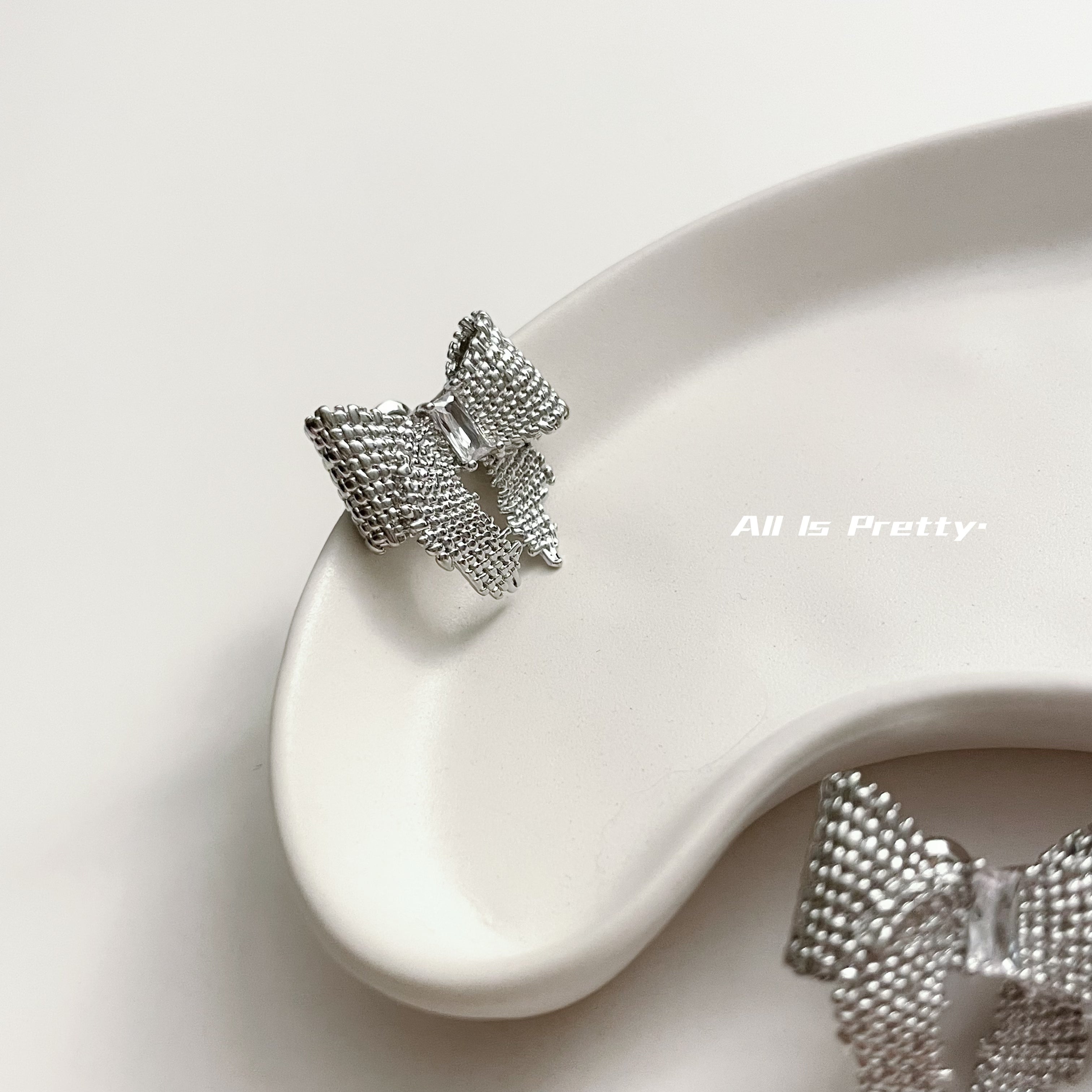 Textured bow studded earrings
