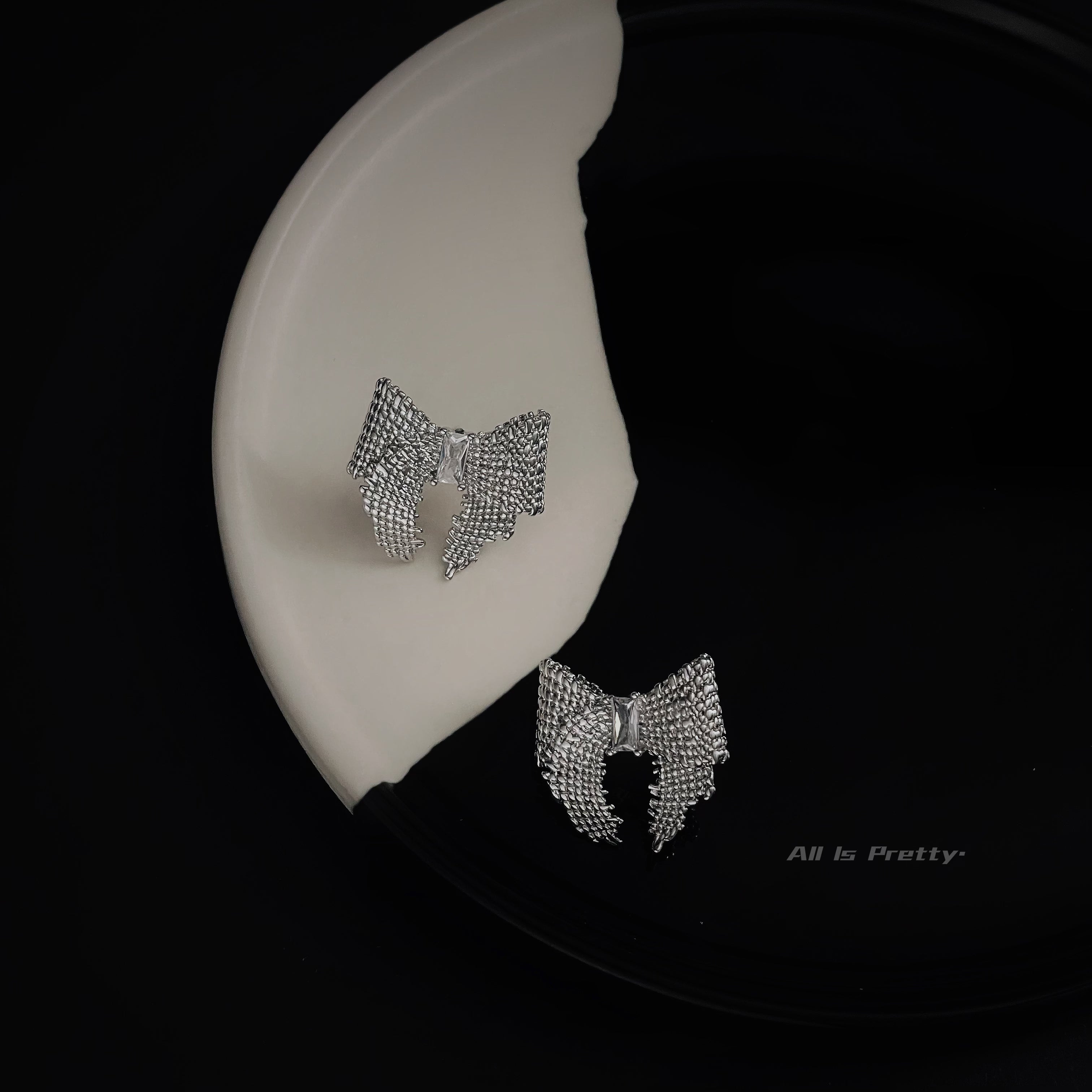 Textured bow studded earrings