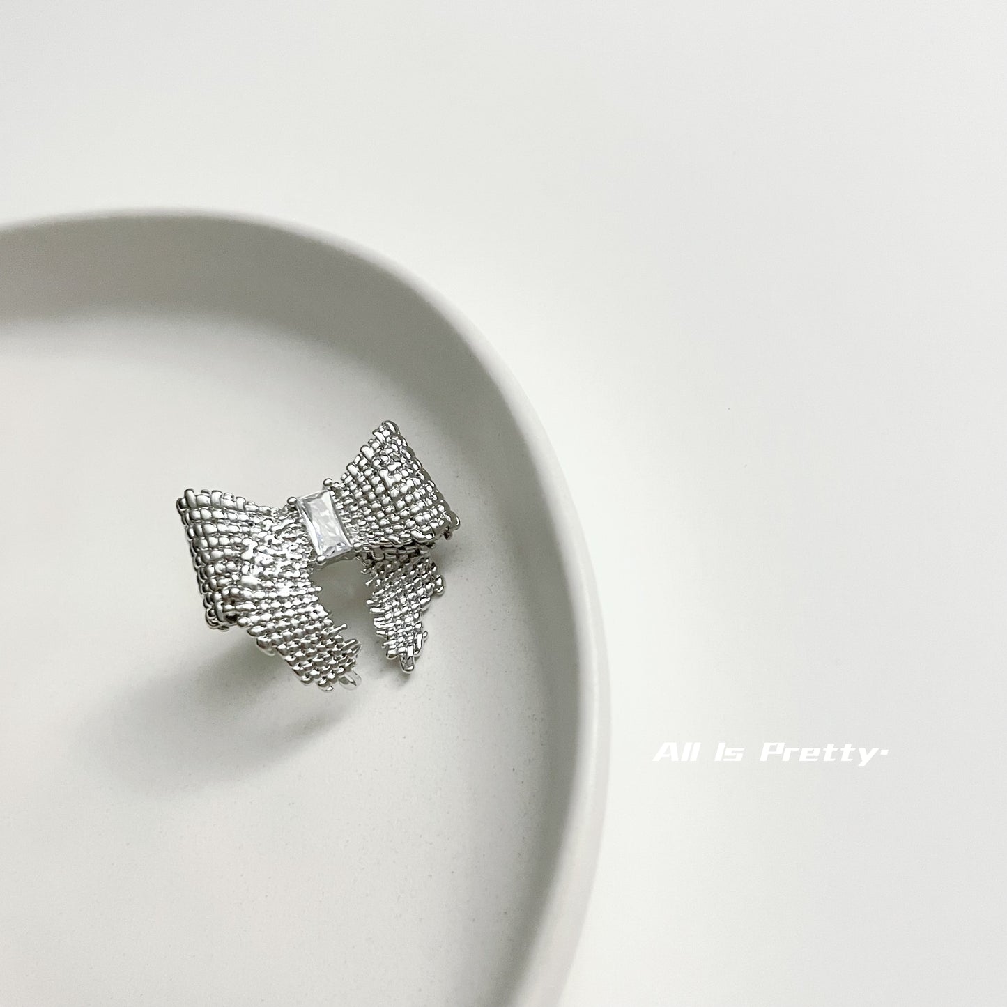 Textured bow studded earrings