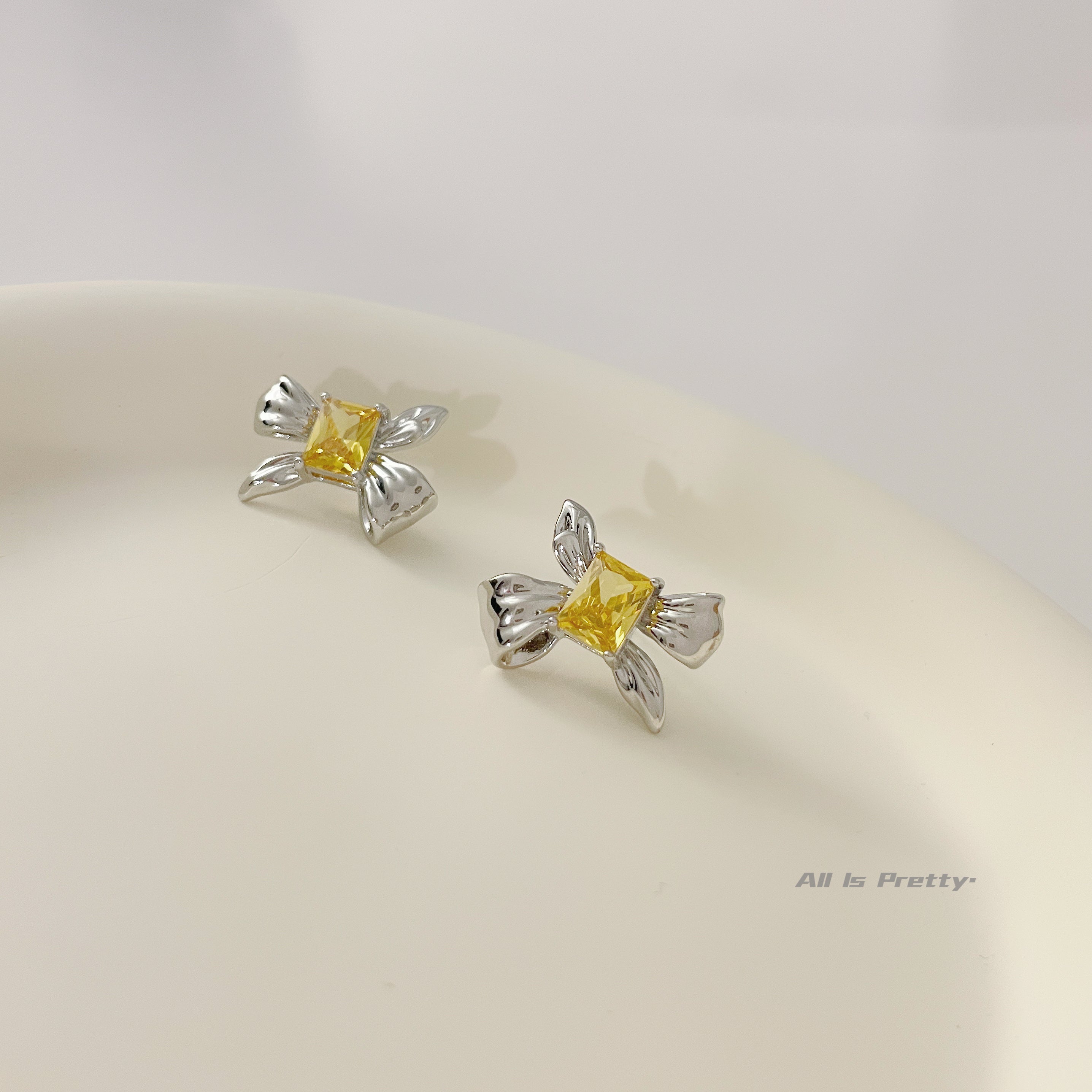 Yellow crystal bow stud earrings