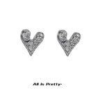 Rough heart shape studded earrings