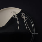 Crystal bow tassel clip earrings