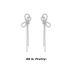 Crystal bow tassel clip earrings
