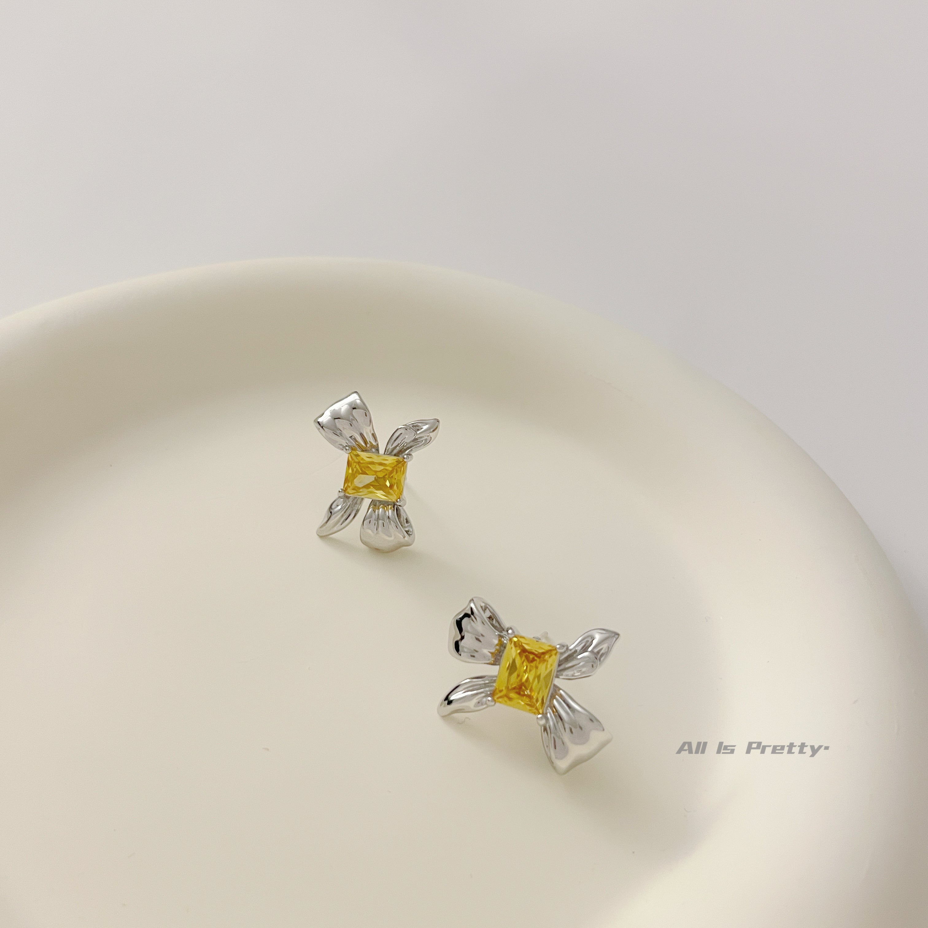 Yellow crystal bow stud earrings